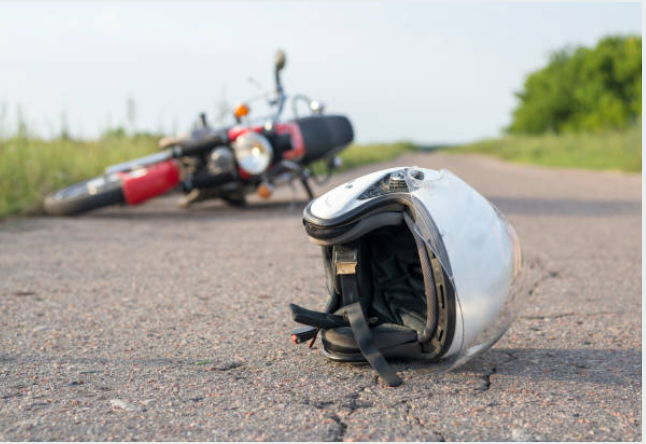 A crashed motorcycle on the side of a road.